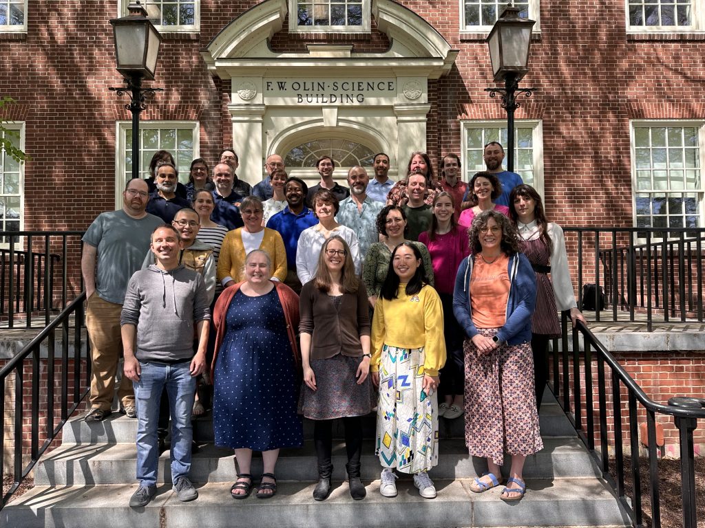Mathematics and Statistics department faculty stand outside of Olin Science Building for a group photo.