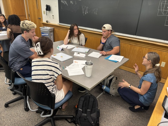 One team talks with Prof. Bickel about the game.